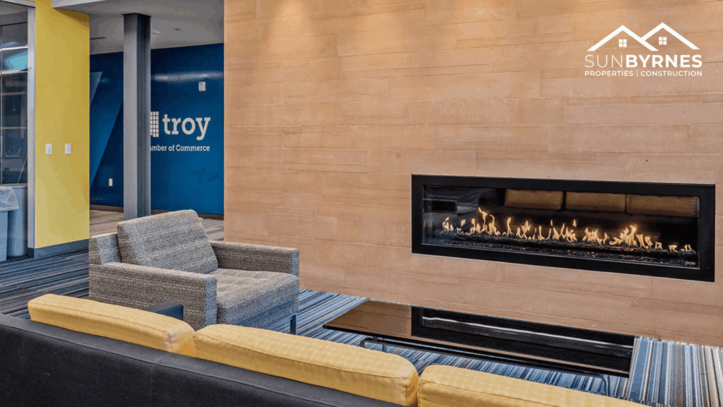 Cozy seating area with a fireplace inside the Troy Chamber of Commerce office, offering a warm and inviting space for meetings or relaxation.